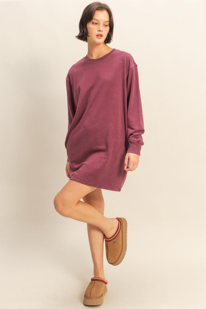 woman wearing a burgundy oversized long sleeve dress and beige slippers