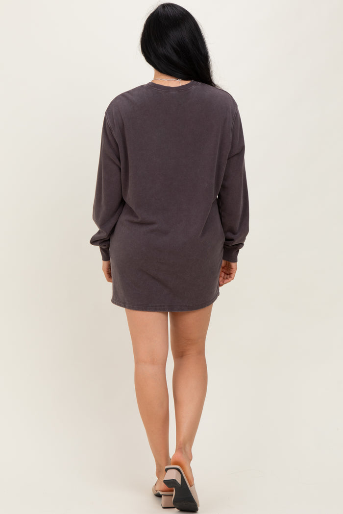 woman wearing a dark gray long sleeve oversized t-shirt dress, seen from the back