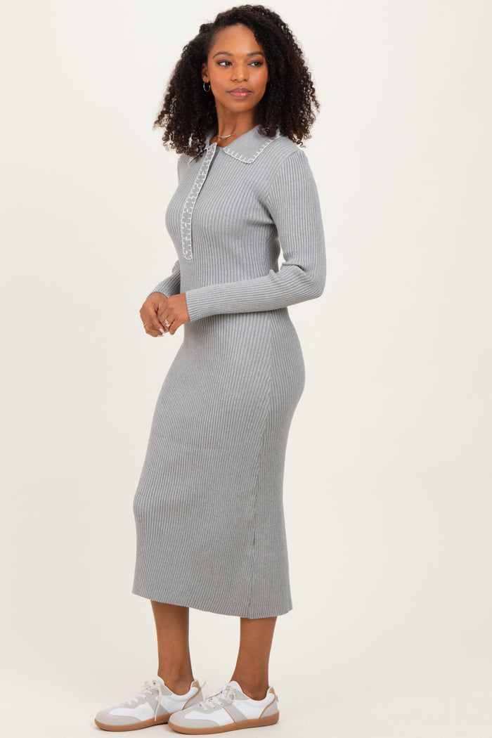 woman wearing a gray ribbed knit midi dress with a collar and long sleeves
