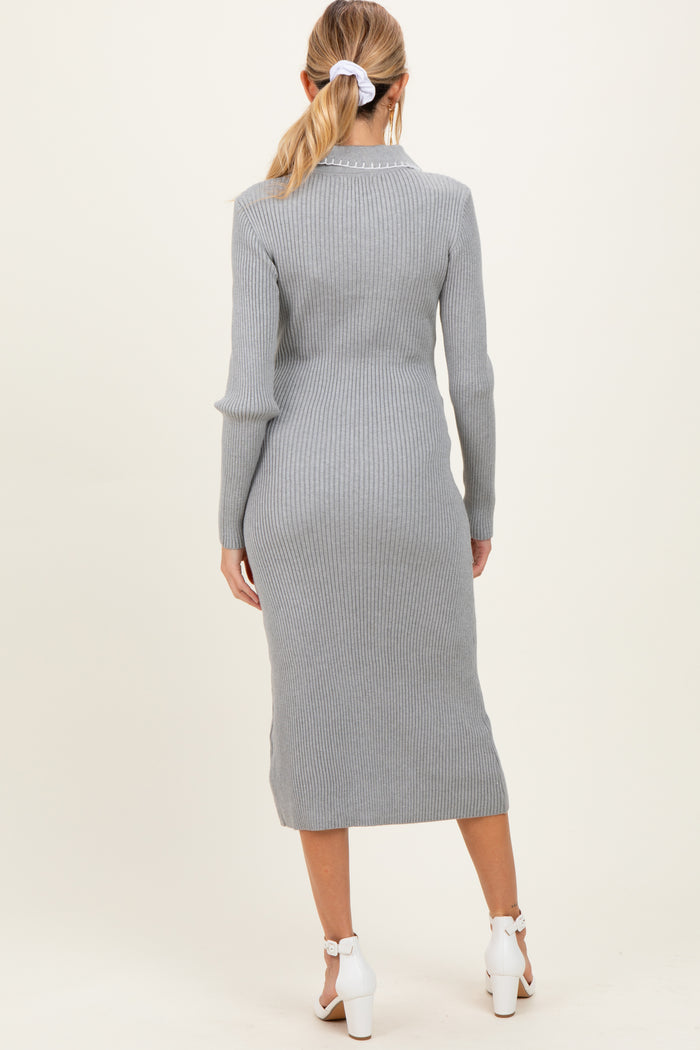 woman wearing a light grey ribbed maternity dress, view from the back, with a fitted silhouette and mid-calf length
