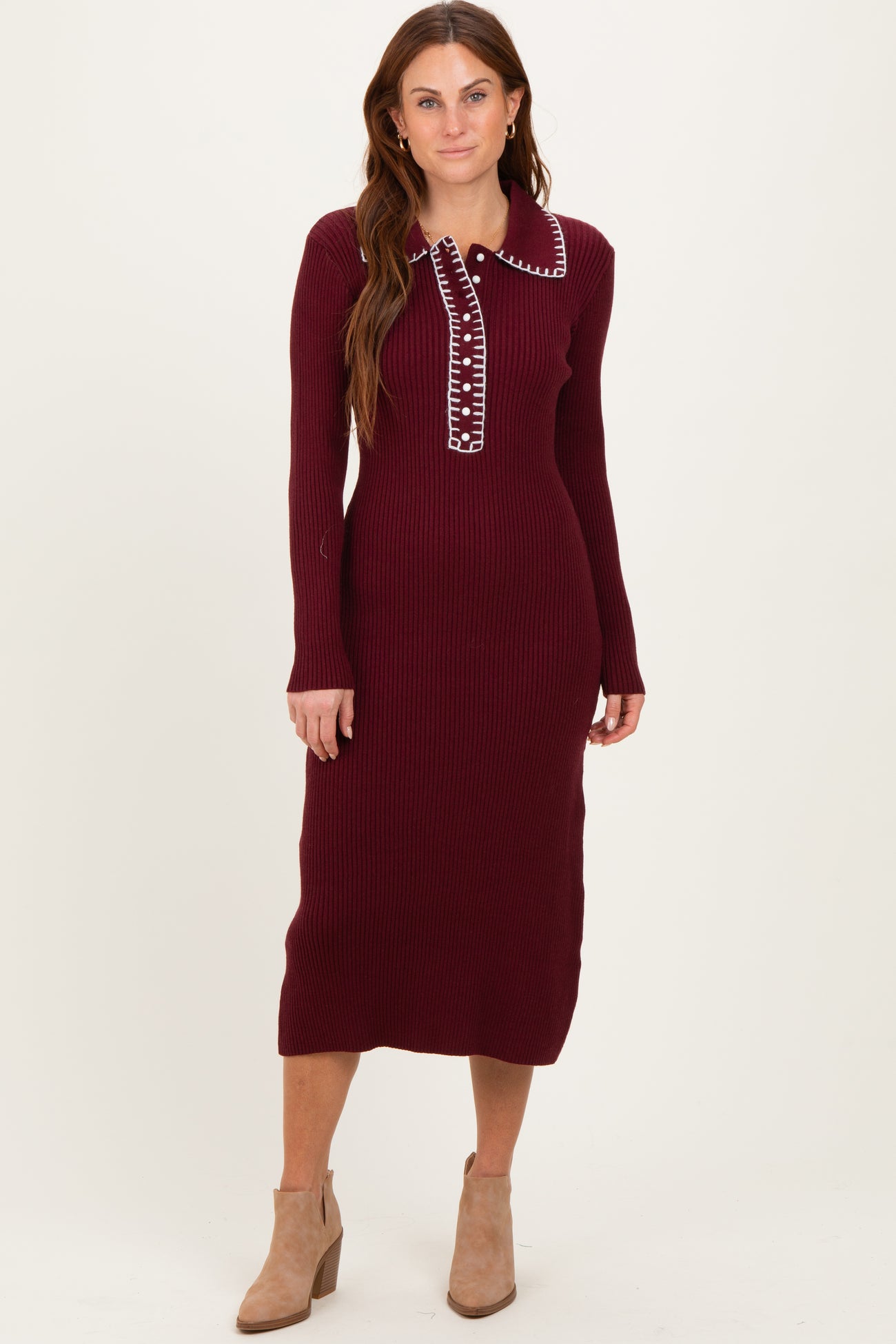 woman wearing a burgundy ribbed midi dress with a collar and button details