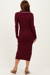 woman wearing a burgundy ribbed long sleeve midi dress with a collared neckline and side slits, viewed from the back