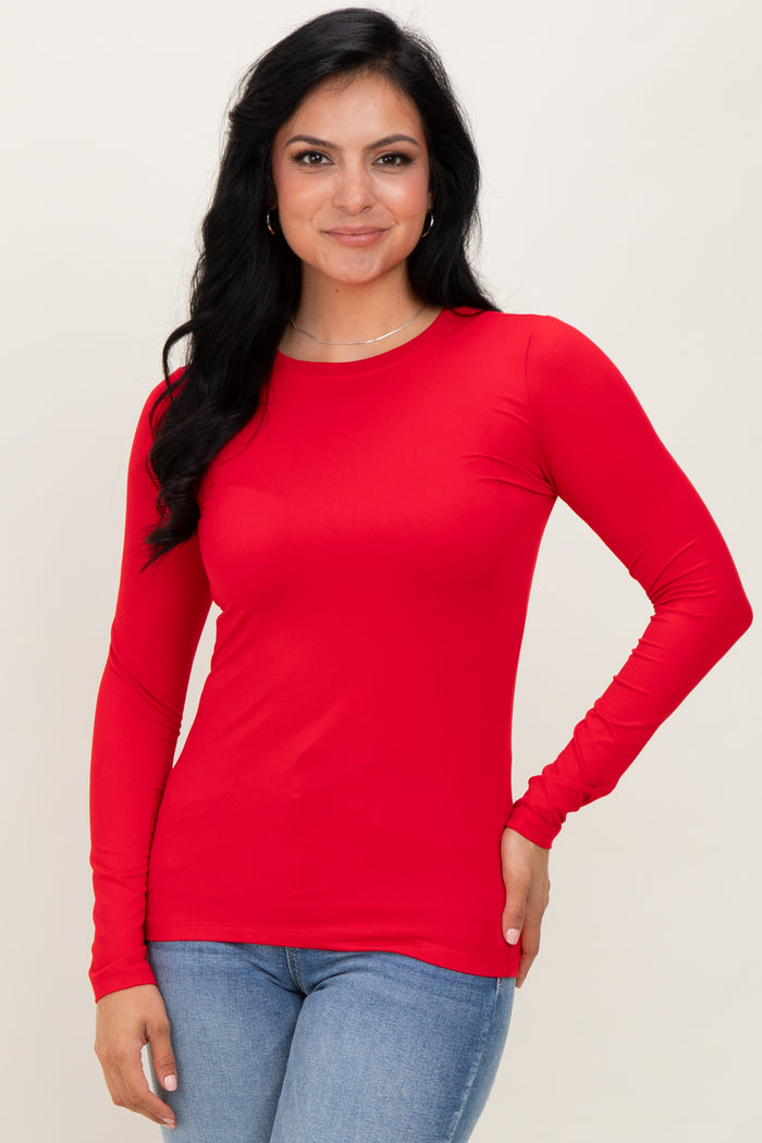 woman wearing a long sleeve bright red top with a fitted style and crew neckline