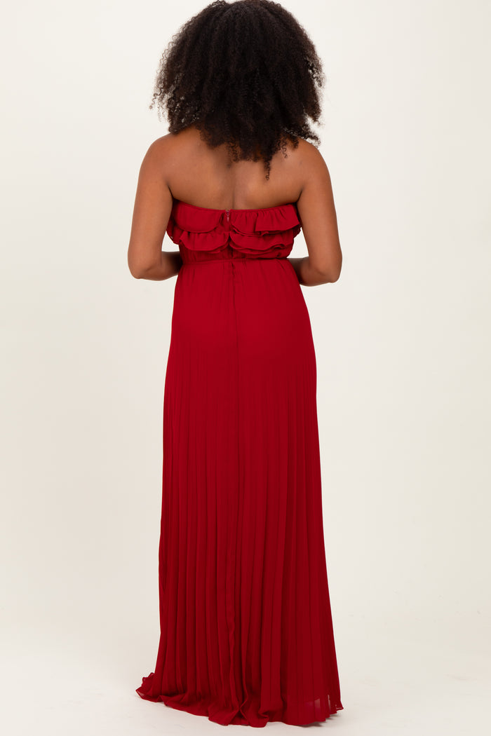 woman wearing a red strapless pleated maxi dress from the back