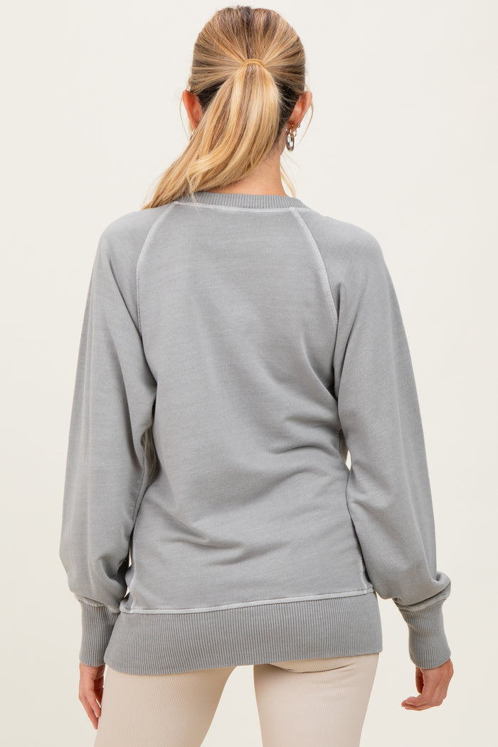 woman wearing a light gray maternity sweatshirt with long sleeves and ribbed hem, showing a relaxed fit from the back