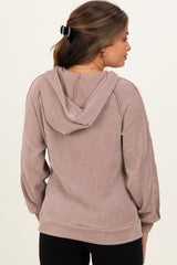 woman wearing a brown ribbed hooded maternity sweatshirt, shown from the back with a loose fit and long sleeves