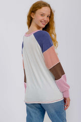 woman wearing a multicolored ribbed sweater with long sleeves and a relaxed fit, showing the back view