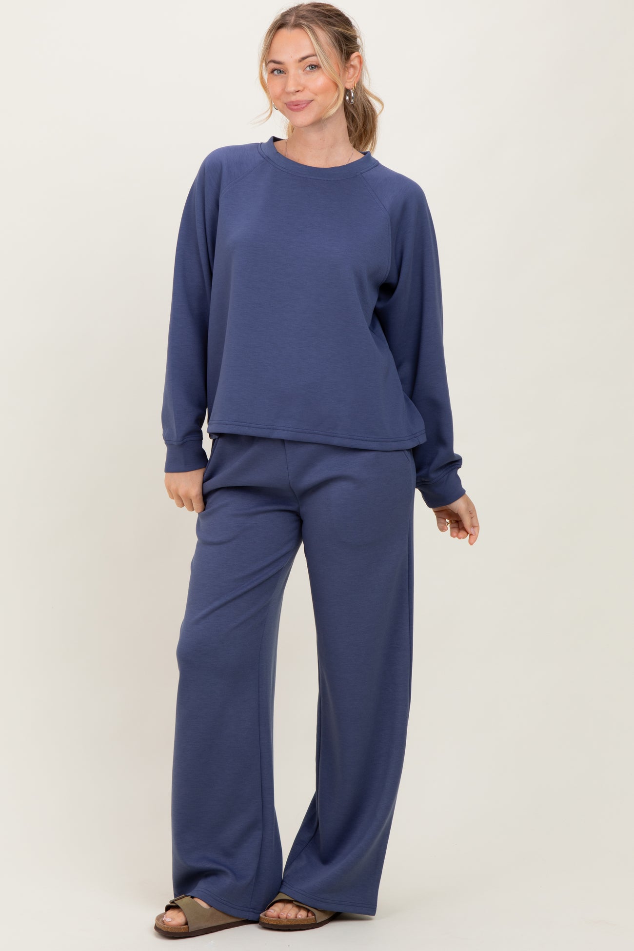 woman wearing a navy blue oversized sweatshirt and matching wide-leg jogger pants