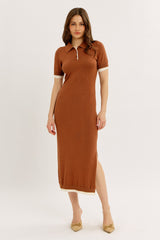woman wearing a rust colored polo style maxi dress with short sleeves and side slit