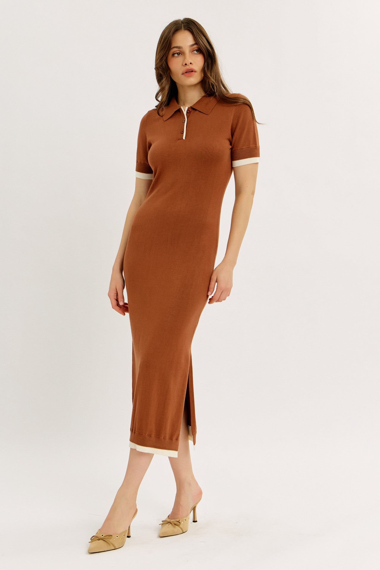 woman wearing a brown ribbed polo dress with short sleeves and side slit, paired with beige heels