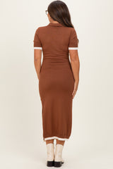 woman wearing a brown short sleeve maternity dress with contrasting white cuffs, shown from the back