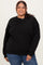 woman wearing a black plus size sweatshirt with loose fit and relaxed sleeves, smiling at the camera