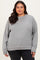 woman wearing a gray oversized sweatshirt with a relaxed fit and ribbed cuffs in a plus size