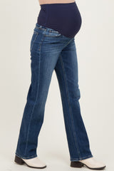 woman wearing a pair of dark blue maternity jeans with a belly panel and a visible baby bump