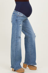 woman wearing distressed light wash maternity jeans with a navy blue waistband and visible baby bump