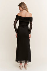 woman wearing a black off-shoulder evening gown with long sheer sleeves and a fitted silhouette