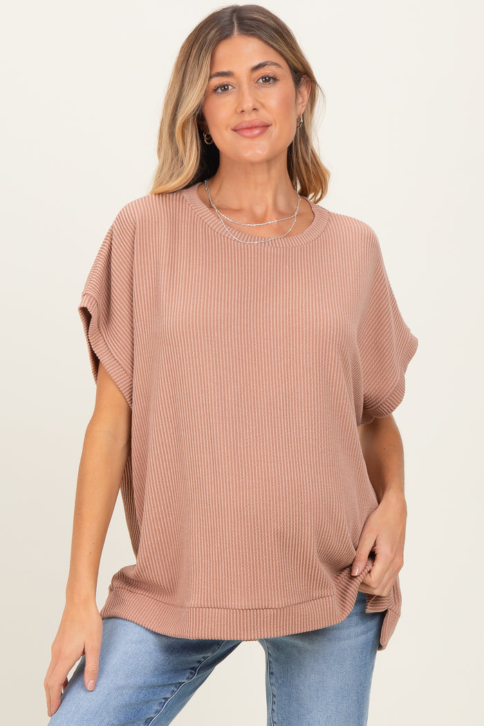 woman wearing a dusty rose oversized ribbed maternity top with short sleeves and a relaxed fit