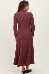 woman wearing a maroon ribbed maternity dress with long sleeves, shown from the back
