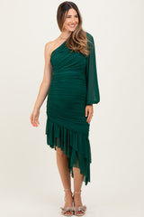 woman wearing a green one-shoulder maternity dress with ruched detailing and a ruffled hemline
