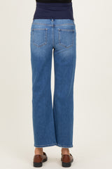 woman wearing high-waisted light blue maternity jeans with a wide leg fit, showing the back view