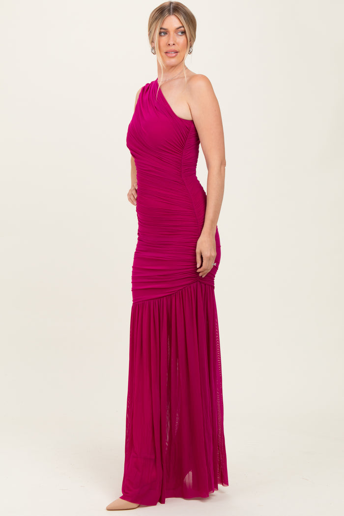 woman wearing a fuchsia one-shoulder evening gown with ruching and a flared hem