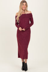woman wearing a burgundy off-the-shoulder long sleeve maxi dress and black ankle boots