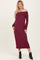 woman wearing a burgundy off-the-shoulder long sleeve dress with fitted silhouette and ribbed fabric