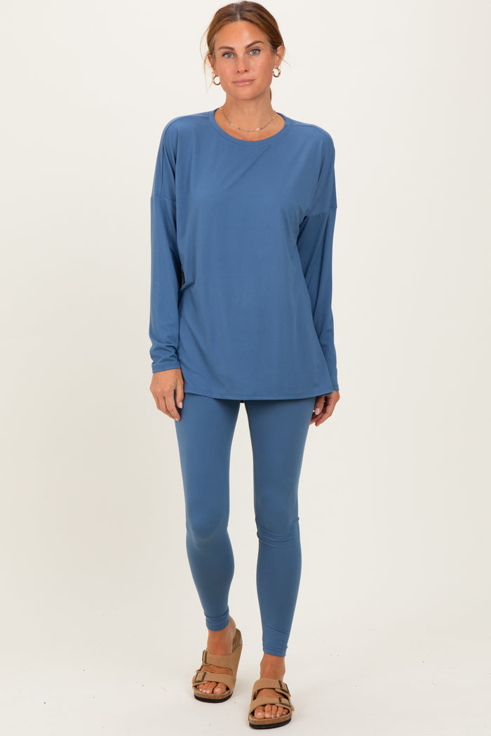 woman wearing a long sleeve blue athletic top and matching blue leggings