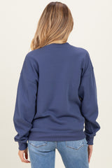 woman wearing a navy blue maternity sweatshirt, view from the back with oversized sleeves and relaxed fit