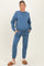 woman wearing a blue maternity sweatshirt and matching sweatpants with pockets and drawstring, styled casually