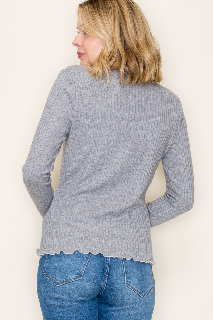 woman wearing a gray ribbed long sleeve sweater with a scalloped hem and back view displayed