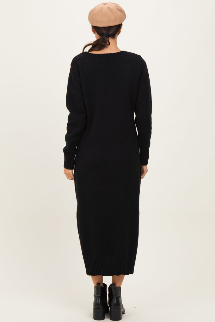 woman wearing a black long sleeve sweater dress, viewed from the back, paired with a beige beret and black ankle boots