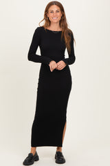 woman wearing a black ribbed long sleeve maxi dress with side slits and chunky black shoes