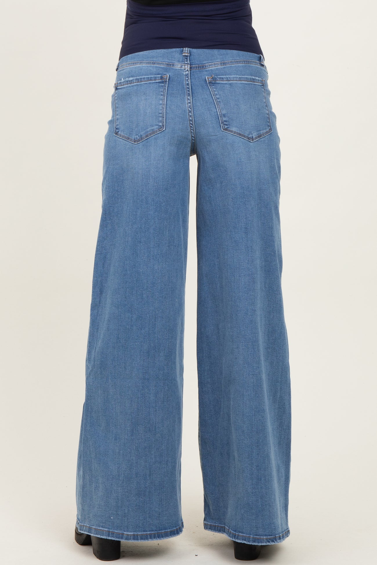 woman wearing light blue wide-leg maternity jeans with back pockets