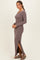 woman wearing a mauve ribbed long sleeve maxi dress with side slits and a scooped neckline