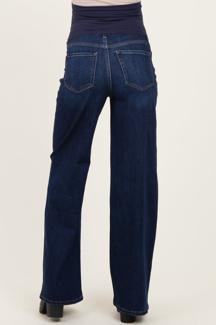 woman wearing dark blue maternity jeans with a wide waistband seen from the back
