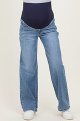 maternity wear blue wide-leg jeans with a navy supportive belly panel, styled with white sneakers