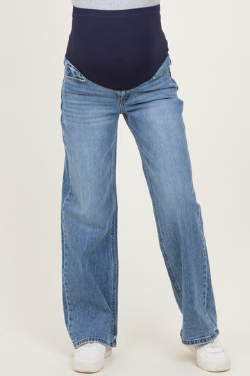 maternity wear blue wide-leg jeans with a navy supportive belly panel, styled with white sneakers
