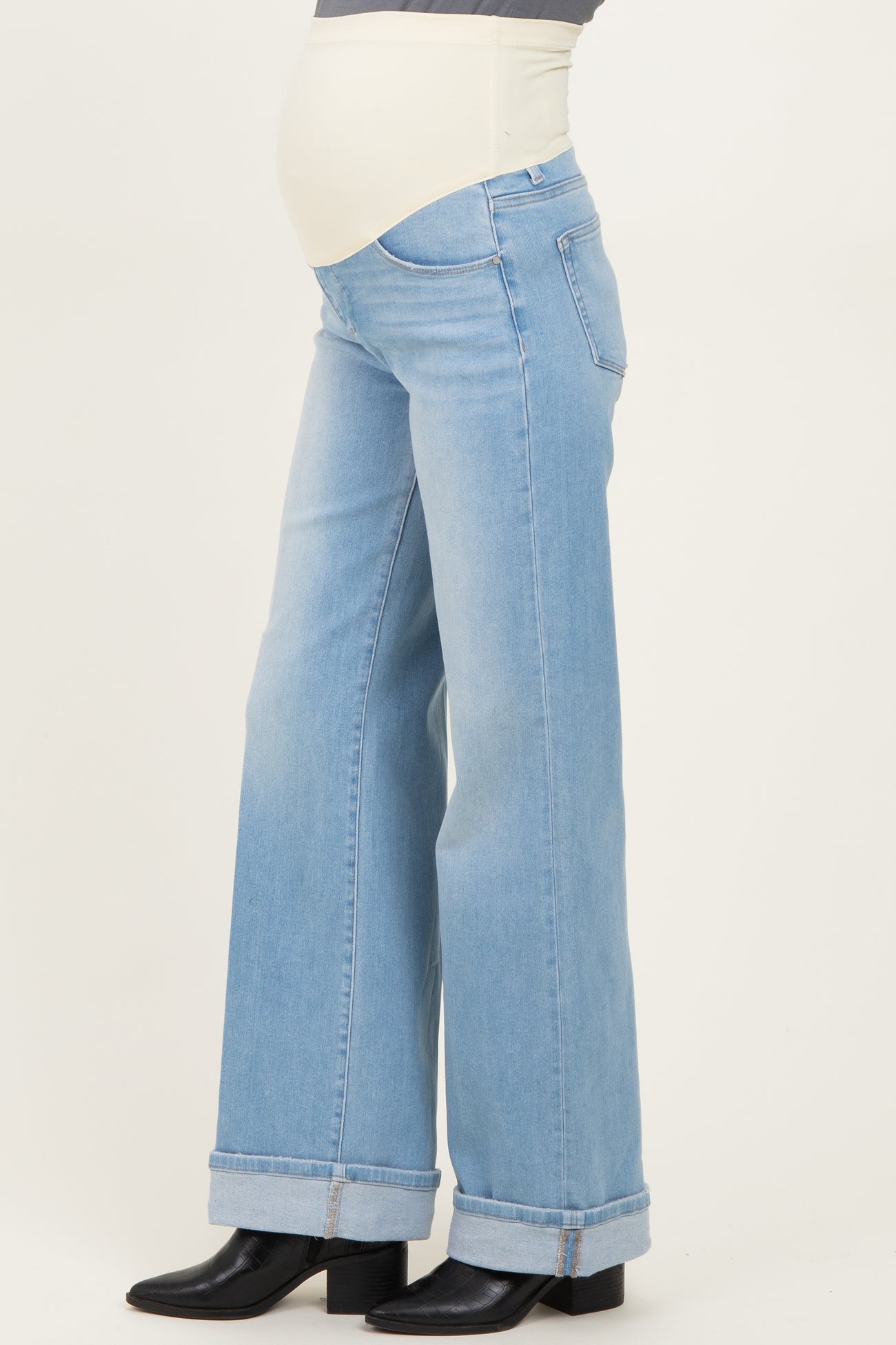woman wearing light blue maternity wide-leg jeans with a stretchy panel for a baby bump