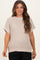 woman wearing a light beige knitted maternity sweater with short sleeves and a relaxed fit