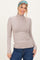 woman wearing a beige long sleeve turtleneck top with a fitted style and light blue and green striped headband