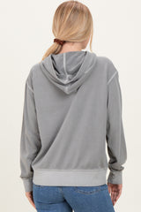 woman wearing a gray hooded sweatshirt with a relaxed fit and kangaroo pocket, shown from the back