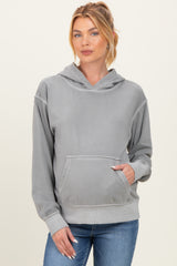 woman wearing a gray maternity hoodie with a front pocket and a hood, paired with jeans