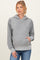 woman wearing a gray maternity hoodie with a front pocket and a hood, paired with jeans