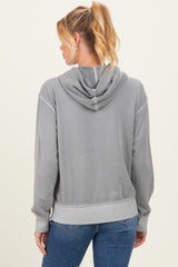 woman wearing a grey maternity hoodie with a back view, featuring a hood and ribbed cuff details