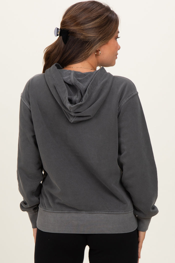 woman wearing a dark gray maternity hoodie with a relaxed fit and a hood, showing the back view