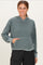 woman wearing a green hooded sweatshirt with a front pocket and relaxed fit
