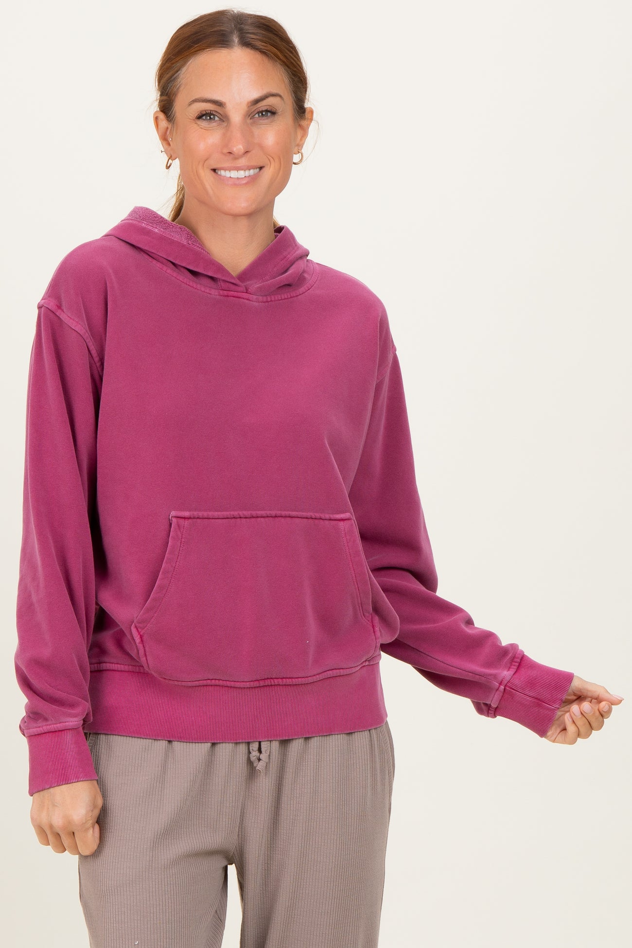 woman wearing a rose pink casual hoodie with a front pocket and relaxed fit