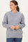 woman wearing a light gray oversized sweater with ribbed texture and a boat neckline, styled with blue jeans