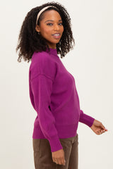 woman wearing a vibrant purple oversized knit sweater with a round neckline and long sleeves